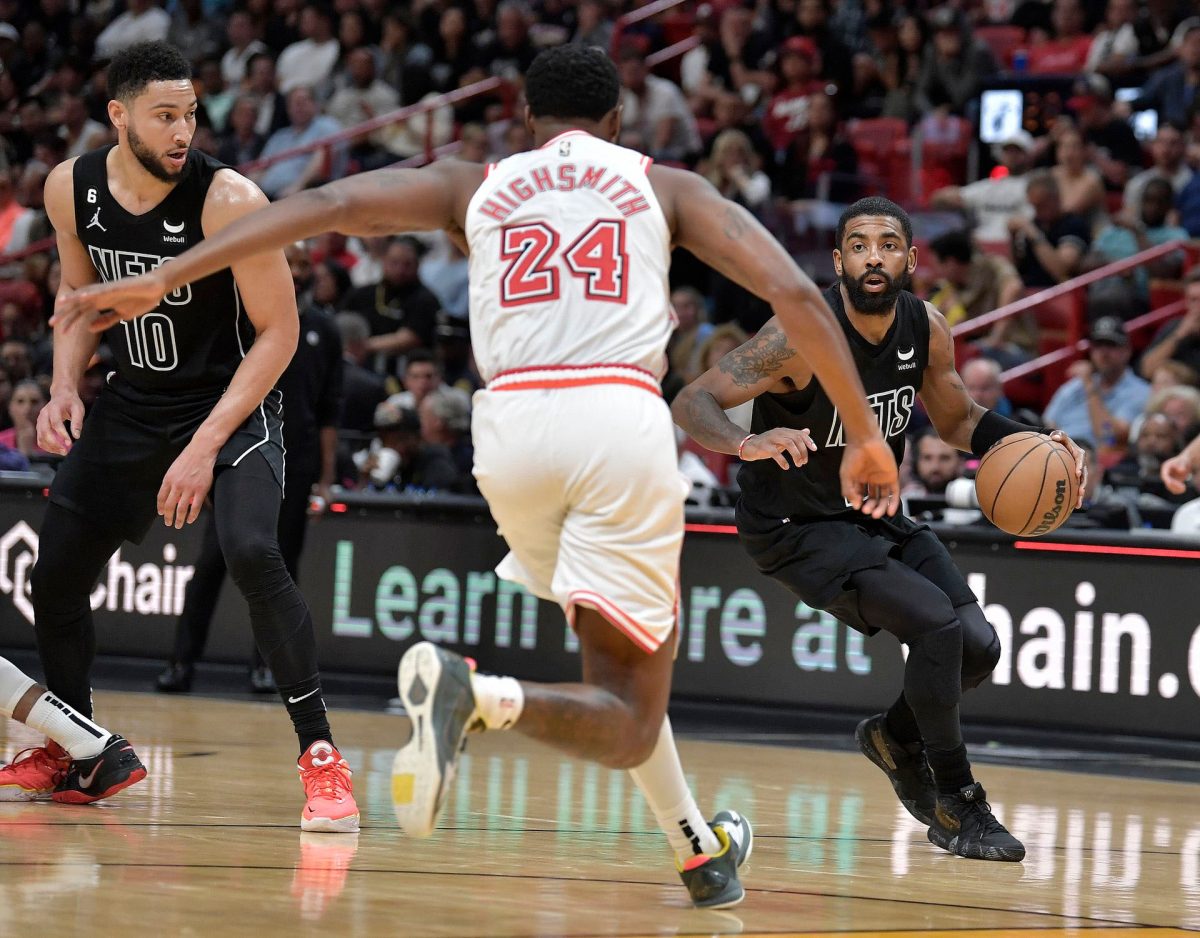 Brooklyn Nets guard Kyrie Irving (11) dribbles the ball at Miami Heat forward Haywood Highsmith (24) during the third quarter at FTX Arena. Mandatory Credit: Michael Laughlin-USA TODAY Sports.