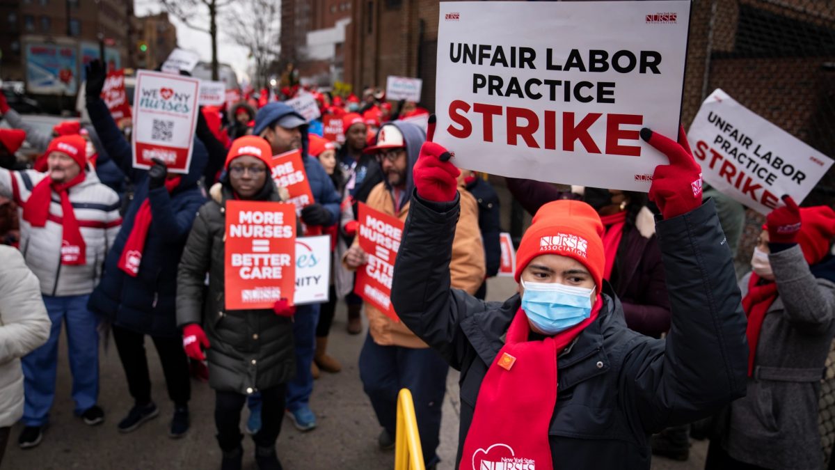 Protestors march on the streets around Montefiore Medical Center during a nursing strike, Wednesday, Jan. 11, 2023, in the Bronx borough of New York. A nursing strike that has disrupted patient care at two of New York City’s largest hospitals has entered its third day. (AP Photo/John Minchillo)