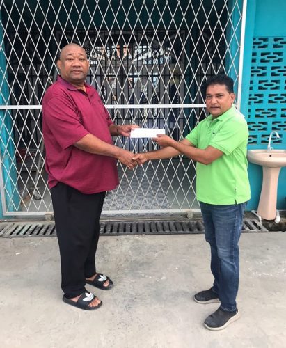 Ramdial Ramoutar (right) of Double R hands over his contribution to BCB President Hilbert Foster.