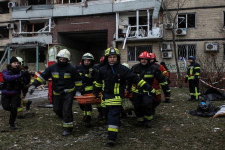Emergency workers carry a woman released from debris at the site where an apartment block was heavily damaged by a Russian missile strike, amid Russia’s attack on Ukraine, in Dnipro, Ukraine January 15, 2023. (Reuters photo)
