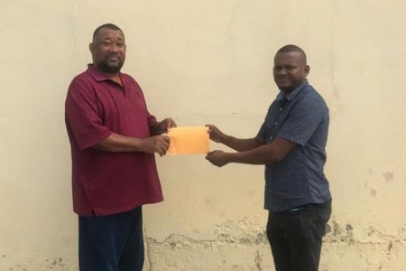 President of the Berbice Cricket Board, Hilbert Foster (left) collects the sponsorship cheque from RL Contracting CEO, Rondhall Lewis