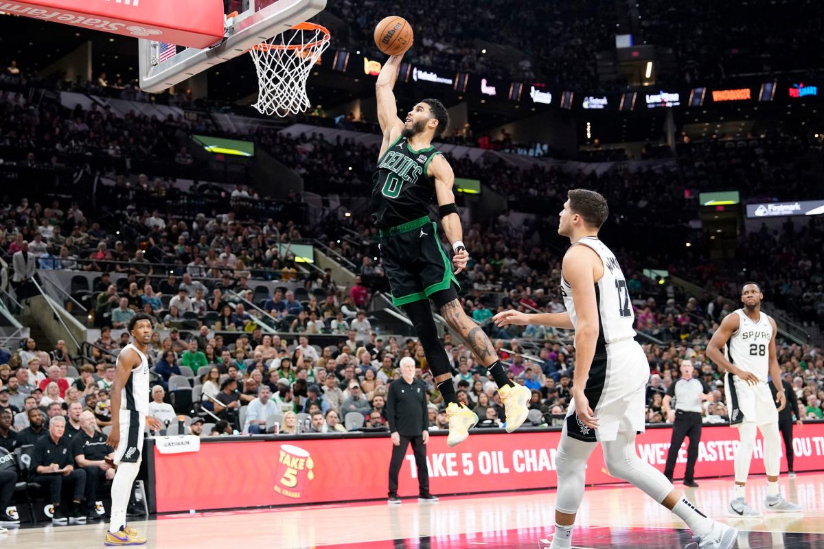 Boston Celtics forward Jayson Tatum (0) dunks over San Antonio Spurs forward Doug McDermott (17) during the second half at AT&T Center. Mandatory Credit: Scott Wachter-USA TODAY Sports.