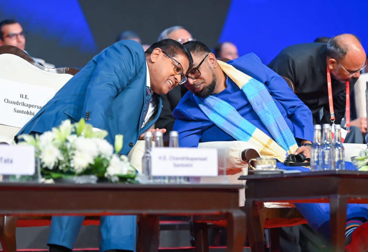 President Irfaan Ali (right) and Surinamese  President Chandrikapersad Santokhi in discussion during the inaugural session of the Global Investors Summit 2023 in Indore, Madhya Pradesh yesterday.  (Office of the President photo)