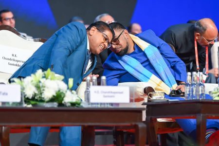 President Irfaan Ali (right) and Surinamese  President Chandrikapersad Santokhi in discussion during the inaugural session of the Global Investors Summit 2023 in Indore, Madhya Pradesh yesterday.  (Office of the President photo)