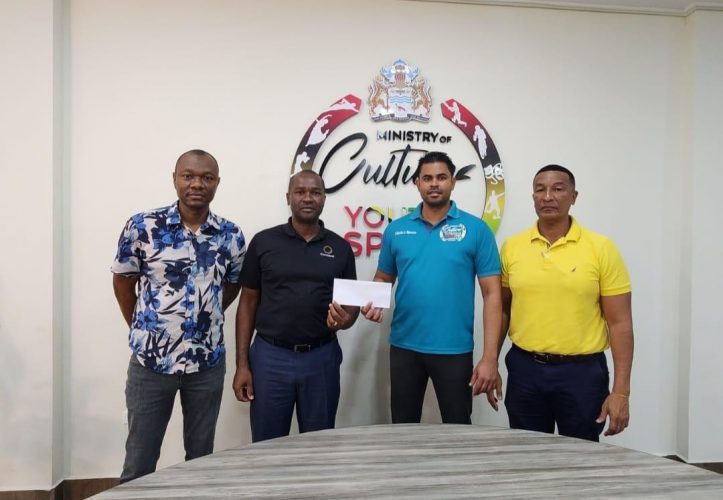  Minister of Culture, Youth and Sport Charles Ramson Jr., (2nd from right) presents the cheque of approximately GYD$32.3M representing prize money and player stipend for the maiden edition of the One Guyana President’s Cup Football Championship which concluded on January 1st to GFF President Wayne Forde. Also in the photo are GFF Vice-President Deon Inniss (left) and NSC Chairman and Kashif and Shanghai Co-Director Kashif Muhammad, right.
