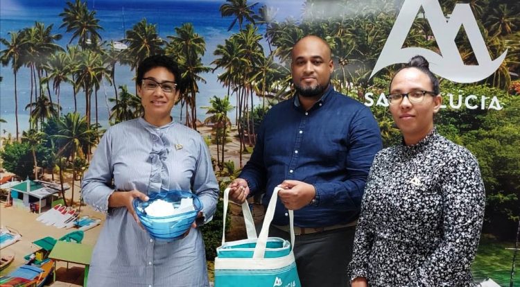 From left Gerain Georges Public Relations Officer, Christopher Gustave Marketing Manager of Caribbean Events and Sports and Kenya James Marketing Officer posing for a photo in St. Lucia as they were about to draw the name of the winner last week 