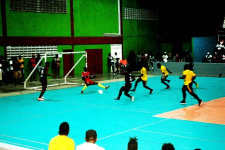 Trayon Bobb (centre/black) slotting the ball under the body of the advancing
Tiger Bay goalkeeper during their semi-final encounter