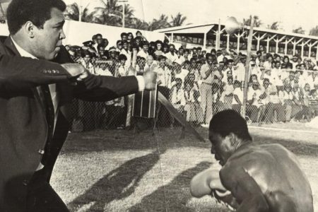  In the picture Ali, left and Ford are involved in an exhibition for the thousands of fans that flocked to see the legendary Ali during his brief visit here.