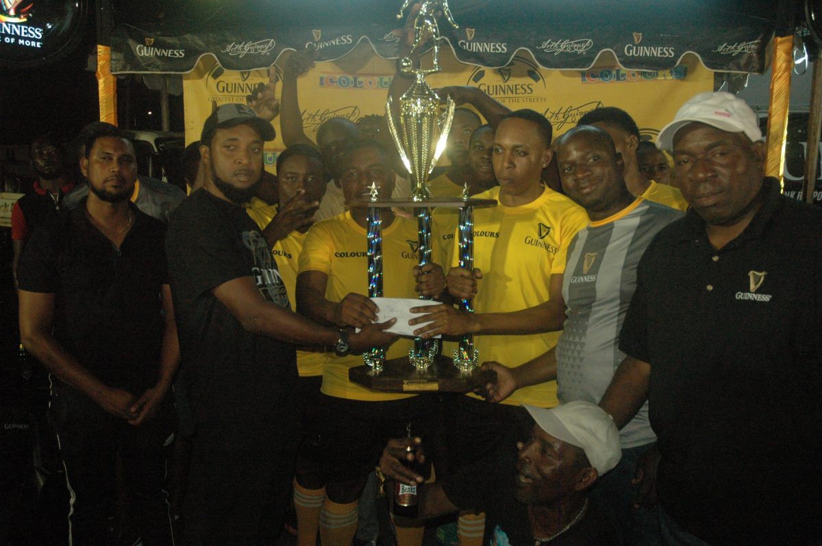 Jeoff Clement, Guinness Brand Manager, presents the championship prize to the Ballerz Empire  outfit after they  won the Guinness ‘Greatest of the Streets’ East Bank/West Demerara leg