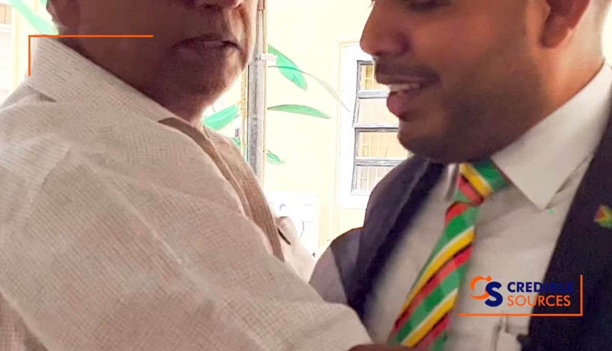 A screen grab of Regional Executive Officer Donald Gajraj (left) attempting to secure the microphone from Chairman Daniel Seeram (right) 