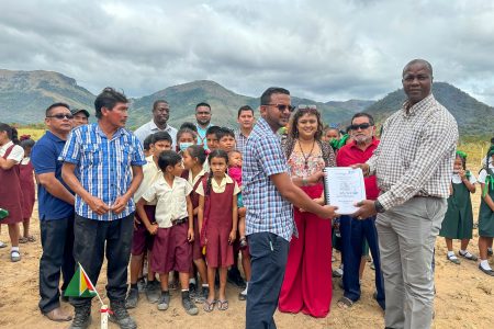 Permanent Secretary of the Ministry of Education, Alfred King (right) and a representative of Avinash Contracting with the signed contract.  (Ministry of Education photo)