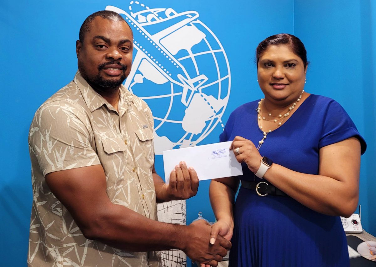 Managing Director of Delight Travel Service, Adriana Singh-Onoja (right) presents the sponsorship cheque to Edison Jefford for the Golden Mile.