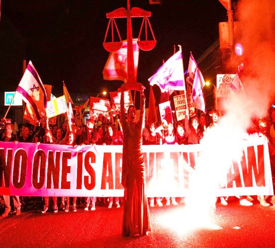 People hold a banner during a protest against Israel’s Prime Minister Benjamin Netanyahu’s new right-wing coalition and its proposed judicial reforms to reduce powers of the Supreme Court in Tel Aviv, Israel February 11, 2023. (Reuters photo)