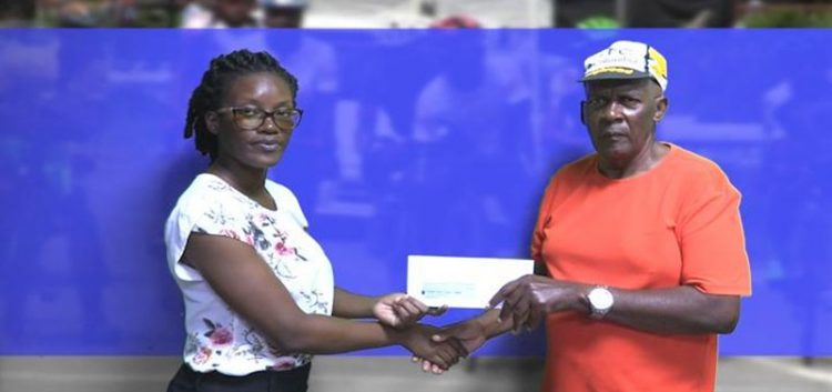  Flying Ace Cycling Club’s Randolph Roberts (right) receives the sponsorship cheque from representative of the sponsors, Malandra Simon.