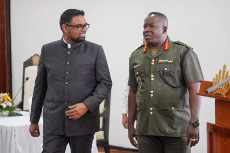 President Irfaan Ali (left) being escorted by outgoing Chief of Staff of the Guyana Defence Force, Brigadier Godfrey Bess at the opening of the GDF’s 35th annual officers’ conference (Office of the President photo)