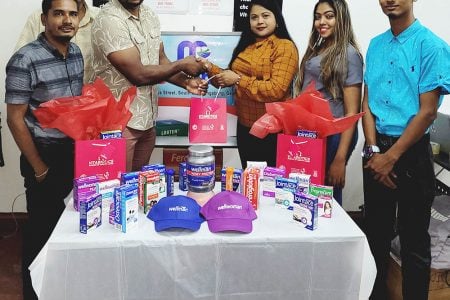 MediPharm Managing Director, Shevani Persaud (third, right) makes the presentation to Edison Jefford in the presence of the MediPharm team from left, Mark Shakoor (Marketing Manager), Prem Tulsie (Transport Officer), Ria Dass (Marketing Executive) and Romel Sookram (Inventory and Logistics Officer).