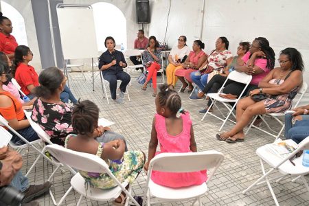 Minister within the Ministry of Housing and Water, Susan Rodrigues (with microphone) speaking to residents of the area (CHPA photo)
