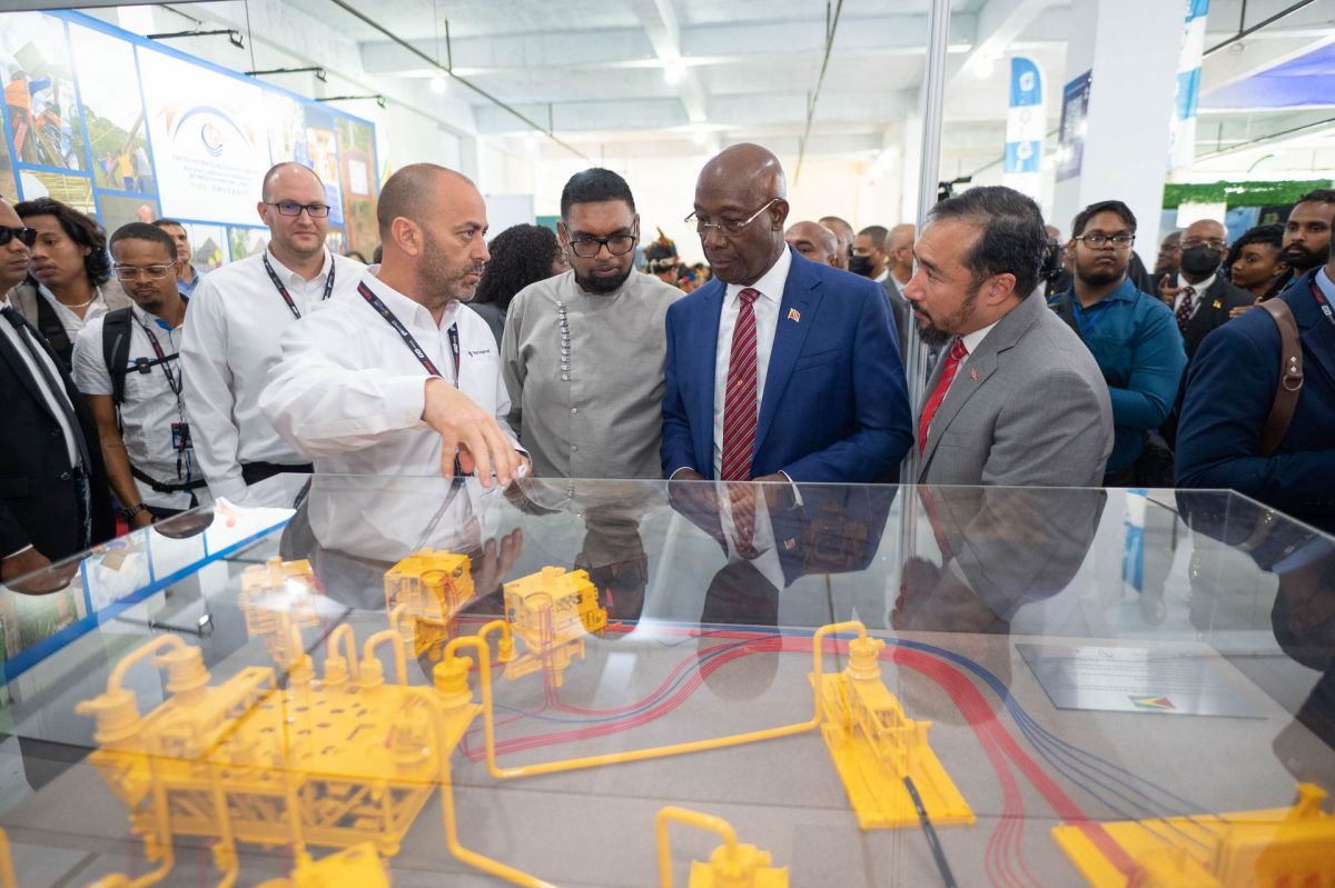 Guyana’s President Dr Mohamed Irfaan Ali, second from left, T&T Prime Minister Dr Keith Rowley and Energy Minister Stuart Young, right, listen to an official from TechnipFMC, left, during the International Energy Conference in Guyana, yesterday.