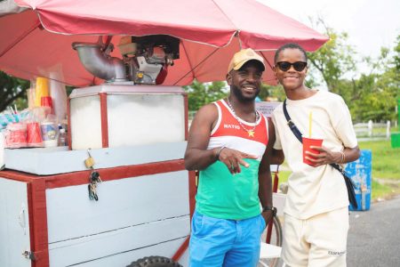Letitia Wright takes a snap with a sno-cone vendor as she holds on to that ice cold sno-cone in a red cup. (Ministry of Tourism, Industry and Commerce photo)