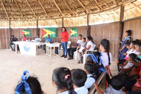 Minister Susan Rodrigues speaking to residents of Taruka (CHPA photo)