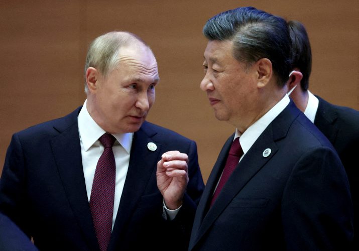 FILE PHOTO: Russian President Vladimir Putin speaks with Chinese President Xi Jinping before an extended-format meeting of heads of the Shanghai Cooperation Organization summit (SCO) member states in Samarkand, Uzbekistan September 16, 2022. Sputnik/Sergey Bobylev/Pool via REUTERS