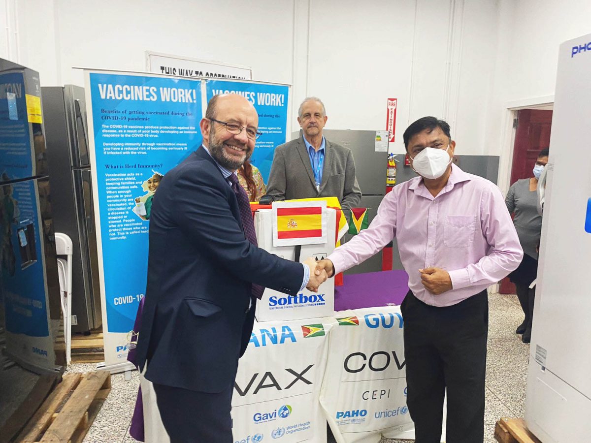 Chief Medical Officer, Dr Narine Singh (right) receiving the donation of vaccines from Spain’s non-resident Ambassador, Fernando Nogales
