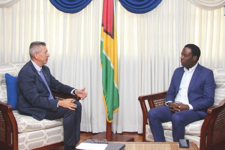 Non-resident Ambassador of the Republic of France to Guyana Nicolás Bouillane de Lacoste (left) in discussion with Minister of Foreign Affairs and International Cooperation, Hugh Todd