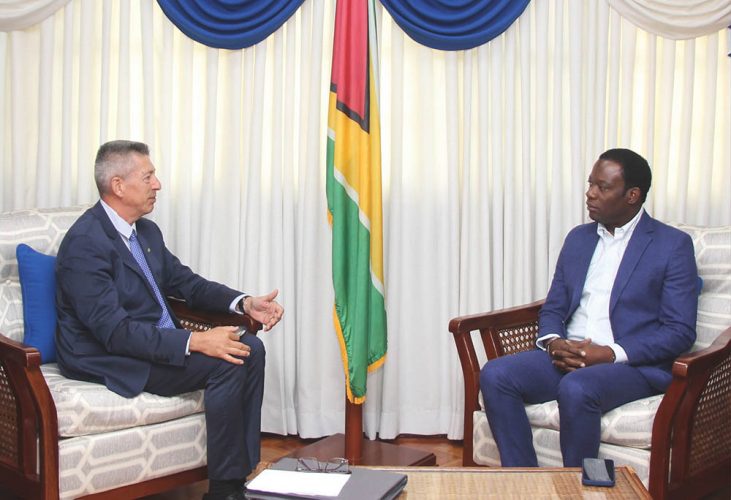 Non-resident Ambassador of the Republic of France to Guyana Nicolás Bouillane de Lacoste (left) in discussion with Minister of Foreign Affairs and International Cooperation, Hugh Todd