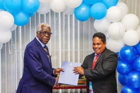 GCAA Director General Egbert Field (left) handing over the certification  to Adrian Bassier (Department of Public Information photo)
