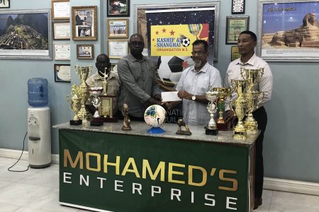 Mohamed’s Enterprise proprietor Nazar Mohamed (2nd from right) presenting the sponsorship cheque to Co-Director of the Kashif and Shanghai Organization, and Chairman of the Guyana Tourism Authority Aubrey Major in the presence of fellow director Kashif Muhammad (1st from right) and Colin Aaron