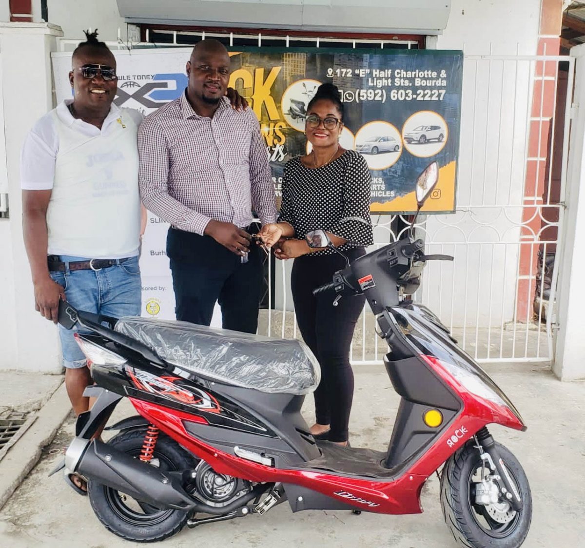 General Manager Yolandia Ross (right) presenting the keys to the motorcycle to organizer Rawle Toney in the presence of company PRO Wayne ‘Harry’ Griffith
 
