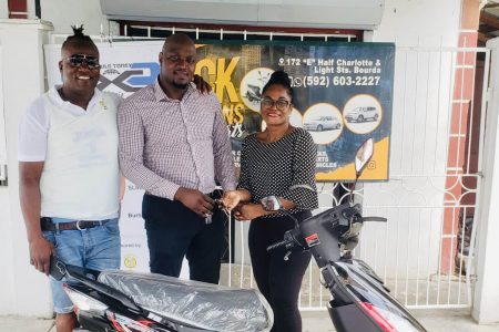 General Manager Yolandia Ross (right) presenting the keys to the motorcycle to organizer Rawle Toney in the presence of company PRO Wayne ‘Harry’ Griffith
 
