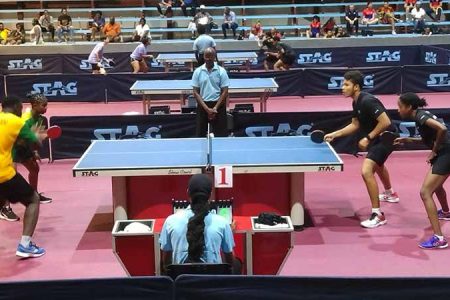 A scene from the mixed doubles quarter-final clash between the Guyanese pair of Jonathan Van Lange/Thuraia Thomas (right) and the Jamaican duo of Joel Butler/Kelsey Davidson in the CRTTF Junior Championship 