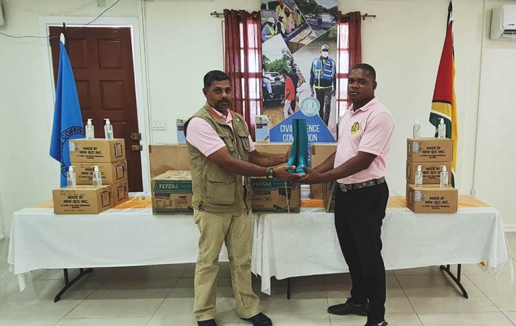 Major Lakshman Persaud (left) making the presentation (CDC photo)
