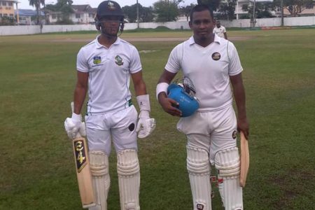 Tevin Imlach, left, and Sachin Singh leave the field after yesterday’s play