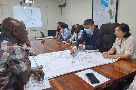 Minister of Public Works, Juan Edghill yesterday had a follow-up meeting with Chinese Ambassador to Guyana, Guo Haiyan, and officials from China Railway Construction Corporation Ltd., to finalise the design interface between the new Demerara River Bridge and the Joe Vieira Park, located at Schoonord, West Bank Demerara.
A release from the Ministry said that the park is in close proximity to where the West Bank end of the new bridge will be constructed.  Edghill was accompanied by Chief Transport Planning Officer in the Ministry of Public Works, Patrick Thompson, and Commissioner of the Protected Areas Commission and the National Parks Commission, Jason Fraser. (Ministry of Public Works photo)