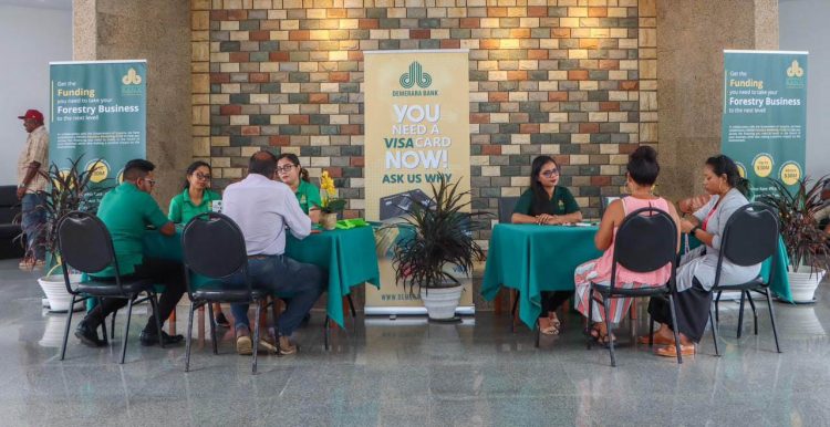 Representatives of Demerara Bank interacting with interested persons on the fund at the launch yesterday. 