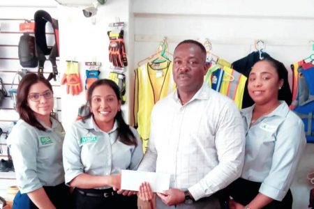 Industrial Safety Supplies Inc. Office Manager, Crystal Kallu hands over sponsorship to WSUCC President Franklin Wilson in the presence of her colleagues, Nyeesha Joseph and Mechaela Hohenkirk.   