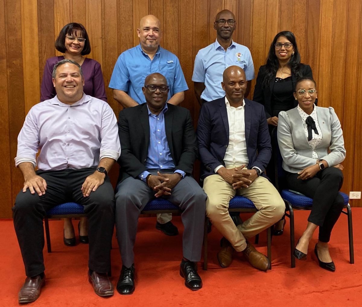 The Guyana Olympic Association is now headed by Godfrey Munroe, (seated second from right). He is flanked by executive members, Vice Presidents, from left, Philip Fernandes, Steve Ninvalle and Cristy Campbell. Standing (from left) are Emelia Ramdhani, Mike Singh, Garfield Wiltshire and Vidushi Persaud-McKinnon. (Emmerson Campbell photo)