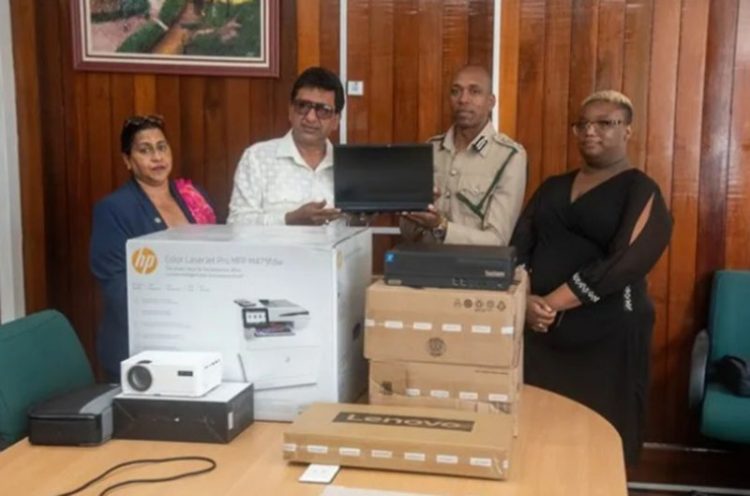 Attorney General and Minister of Legal Affairs Anil Nandlall handing over the IT equipment to Director of Prisons, Nicklon Elliot 