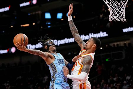  Memphis Grizzlies guard Ja Morant (12) goes to the basket against Atlanta Hawks forward John Collins (20) during the second half at State Farm Arena. Mandatory Credit: Dale Zanine-USA TODAY Sports