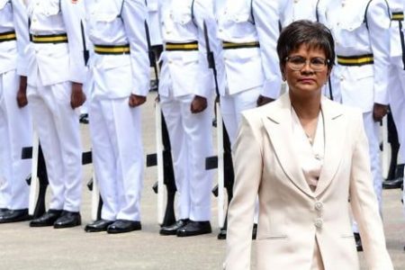 Christine Kangaloo inspecting the Guard of Honour after her swearing in.