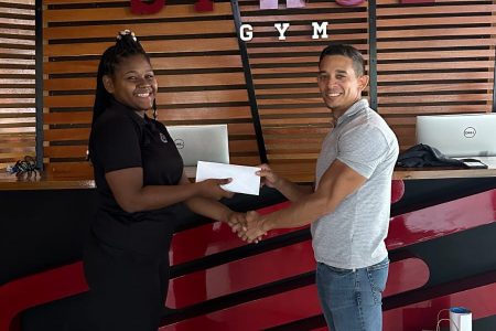 Jennifer Thomas, a representative of Space Gym 2.0, presented the gym’s sponsorship package to organizer of the Kares Crossfit Caribbean Championship, Jamie McDonald for the successful hosting of the two-day competition.