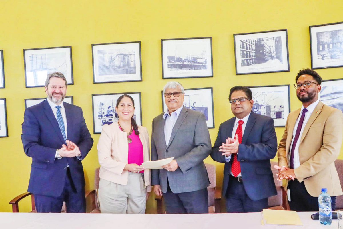 Executive Chairman of DDL, Komal Samaroo (centre) and IDB Resident Representative Lorena Solorzano-Salazar holding the loan document.  Minister of Finance Ashni Singh is second from right. (Ministry of Finance photo)