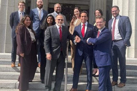 Faris Al-Rawi, second from right front, with the winning team from the New York law firm who represented T&T in the Piarco Airport civil matter, outside the Miami Dade Circuit Court yesterday.