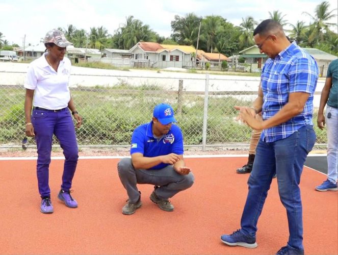 From left,  Assistant Director of Sport, Melissa Dow-Richardson, Minister of Sports, Charles Ramson Jr., and Chairman of the National Sports Commission, Kashif Muhammad, inspecting the site at Bayroc, Linden, where the laying of a synthetic track has commenced. (Photo courtesy Facebook)