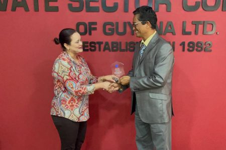 Luanna Persaud receiving her award from PSC Chair Paul Cheong