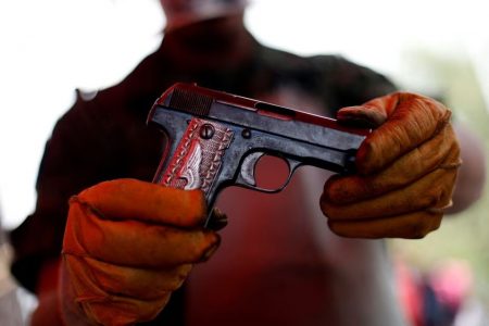 A soldier shows a gun delivered by a citizen as part of a voluntary disarmament program in Mexico City, Mexico April 3, 2019.REUTERS/Edgard Garrido/File Photo