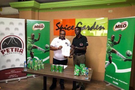 Petra Organization Co-Director Troy Mendonca (left) displays the event fixtures alongside entity member Mark Alleyne.