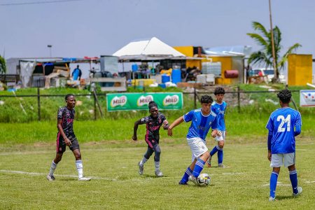 A scene from the opening game in the 9th edition of the Milo Secondary Schools Football Championship between Marian Academy (blue) and Eats Ruimveldt